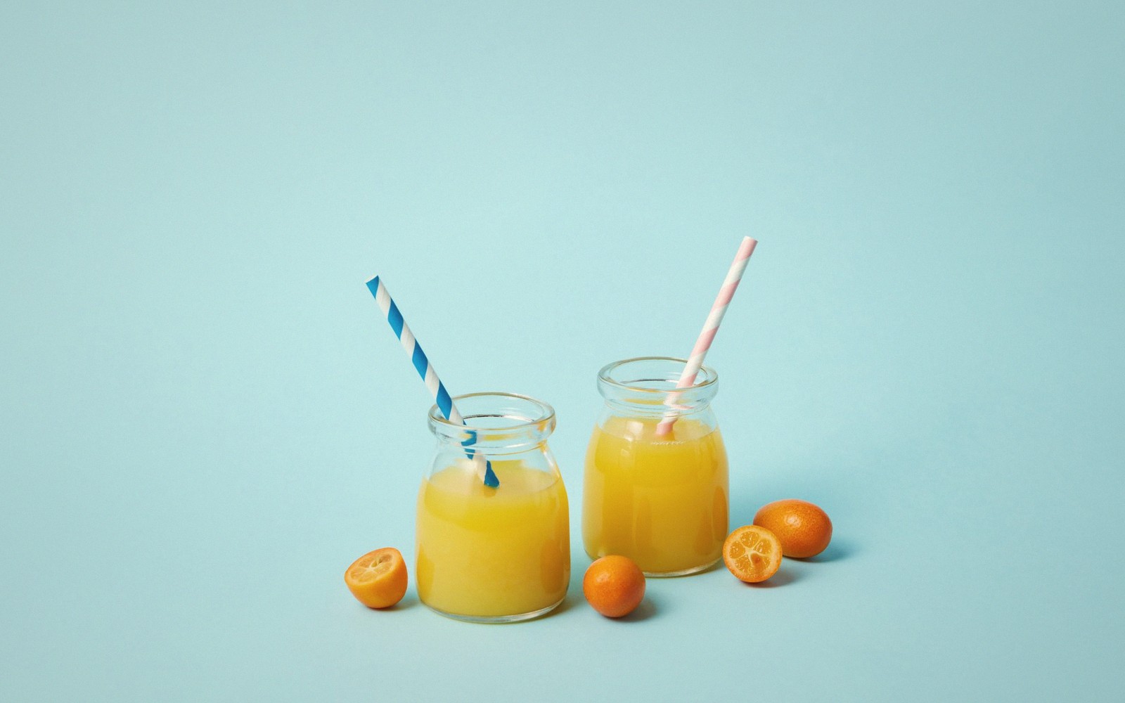 Carafes of fresh green, orange and red juice